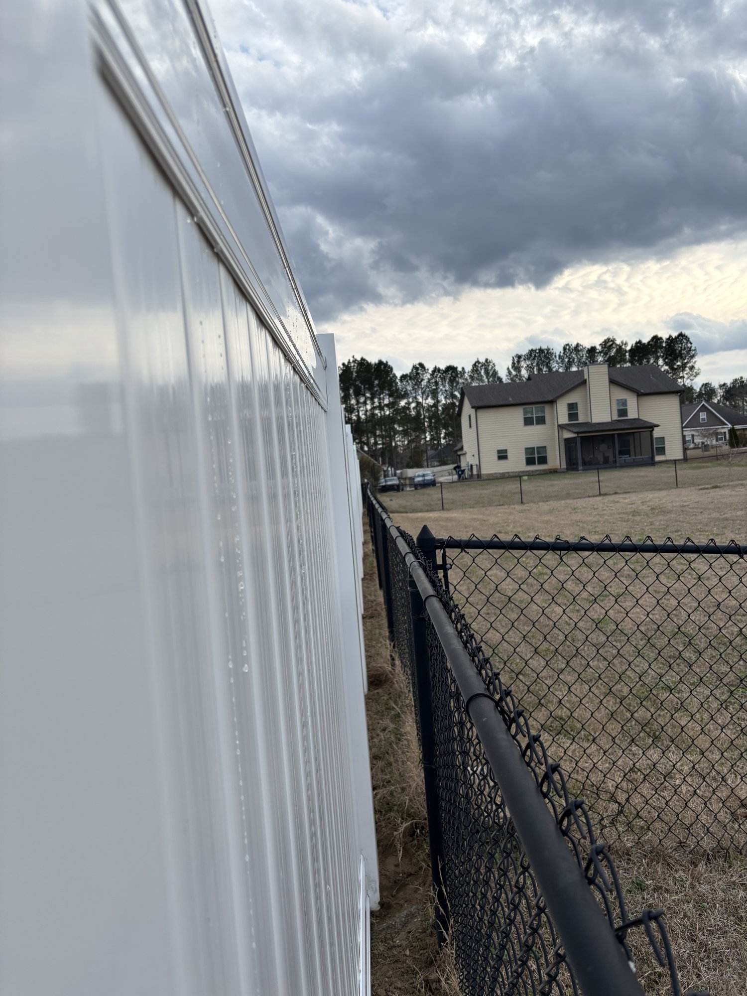 White vinyl privacy fence detail with crisp post caps